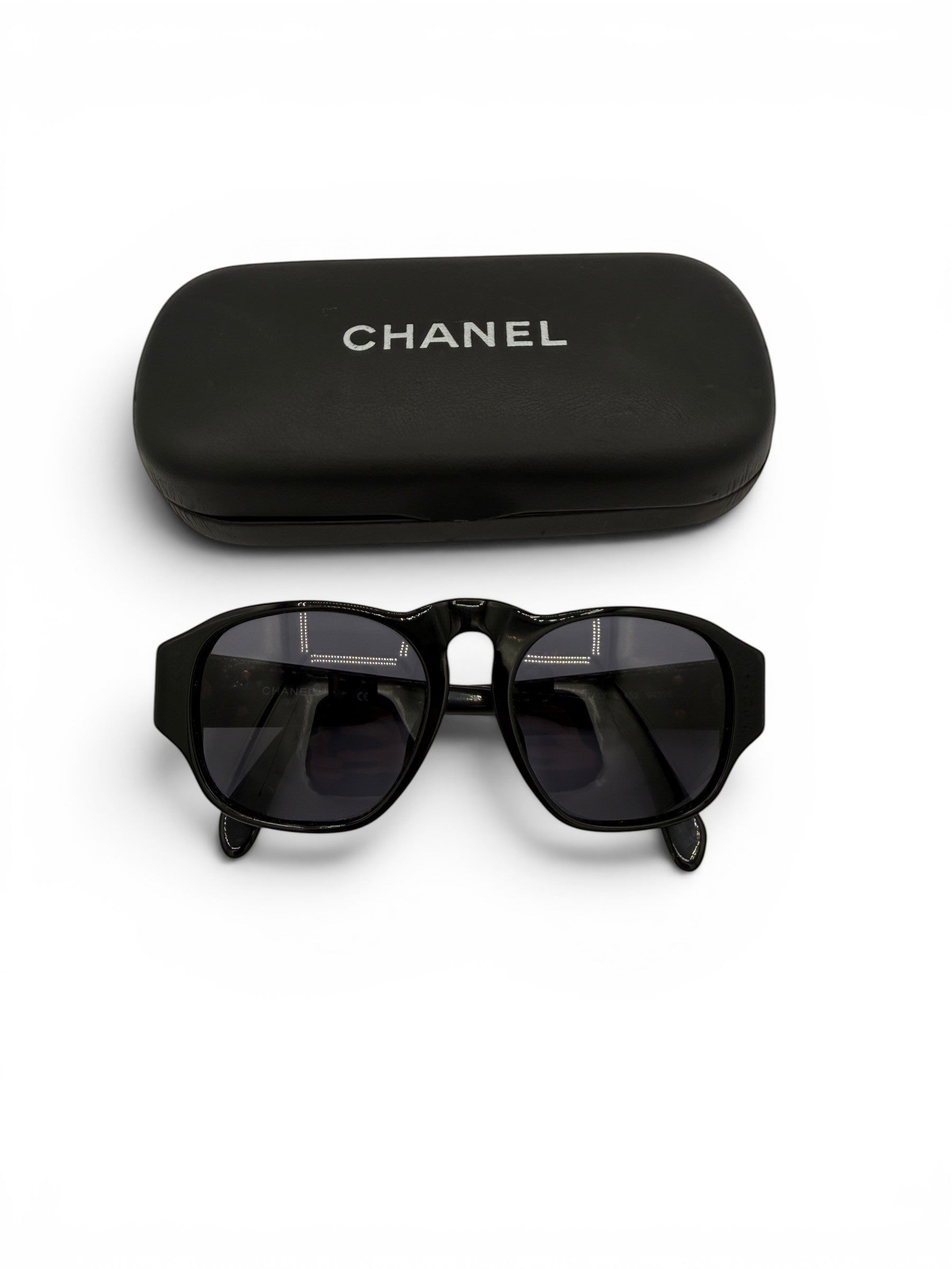 Curated Closet Vintage Chanel 01452 black acetate sunglasses with gold CC logos and dark lenses.